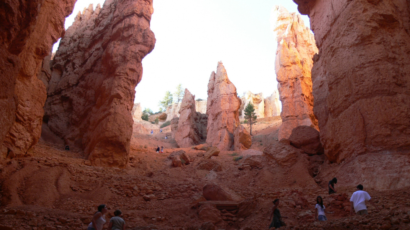 People Walking on Brown Rock Formation During Daytime. Wallpaper in 1366x768 Resolution