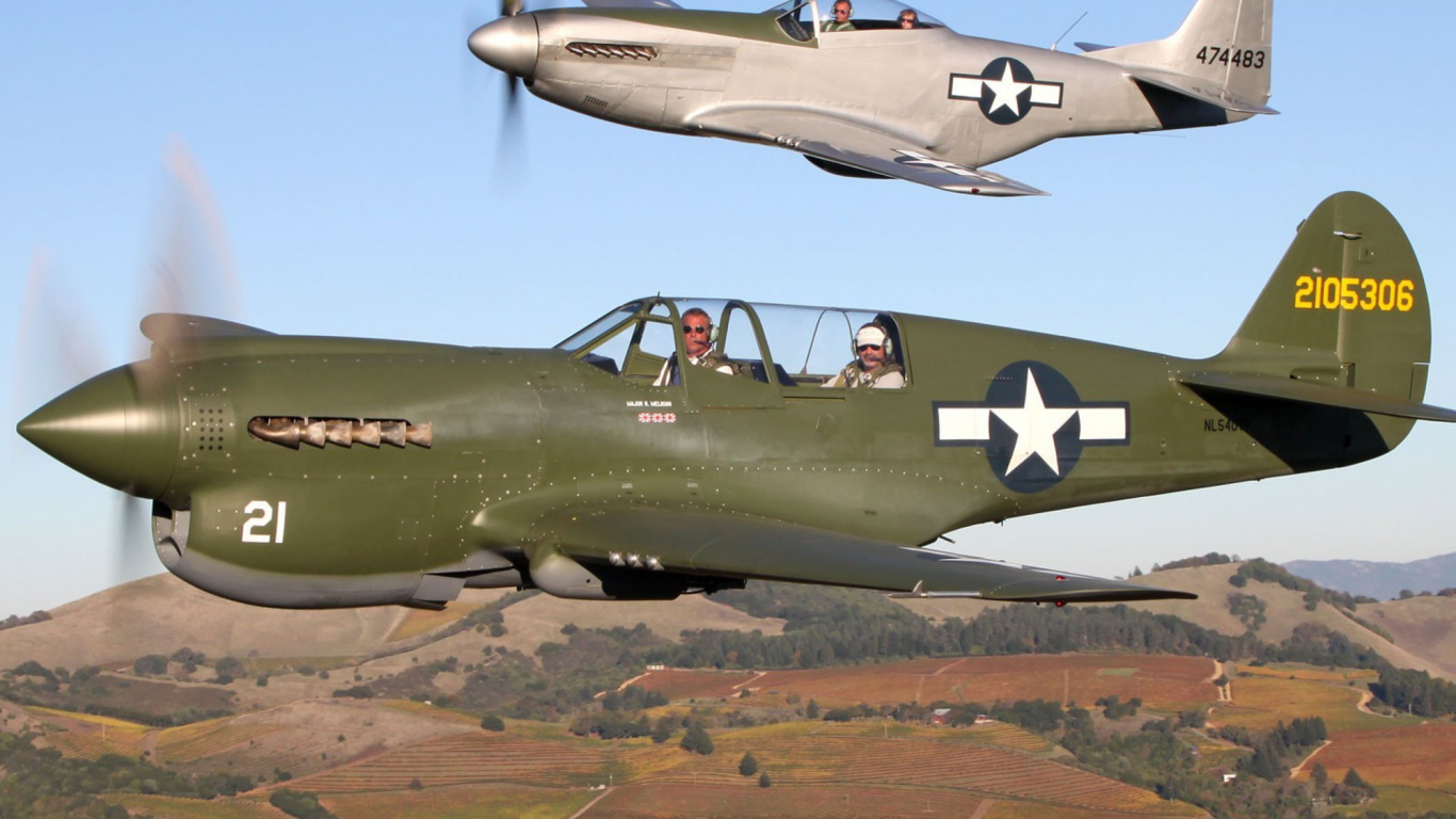 Green and Black Fighter Plane Flying Over Brown Field During Daytime. Wallpaper in 1366x768 Resolution