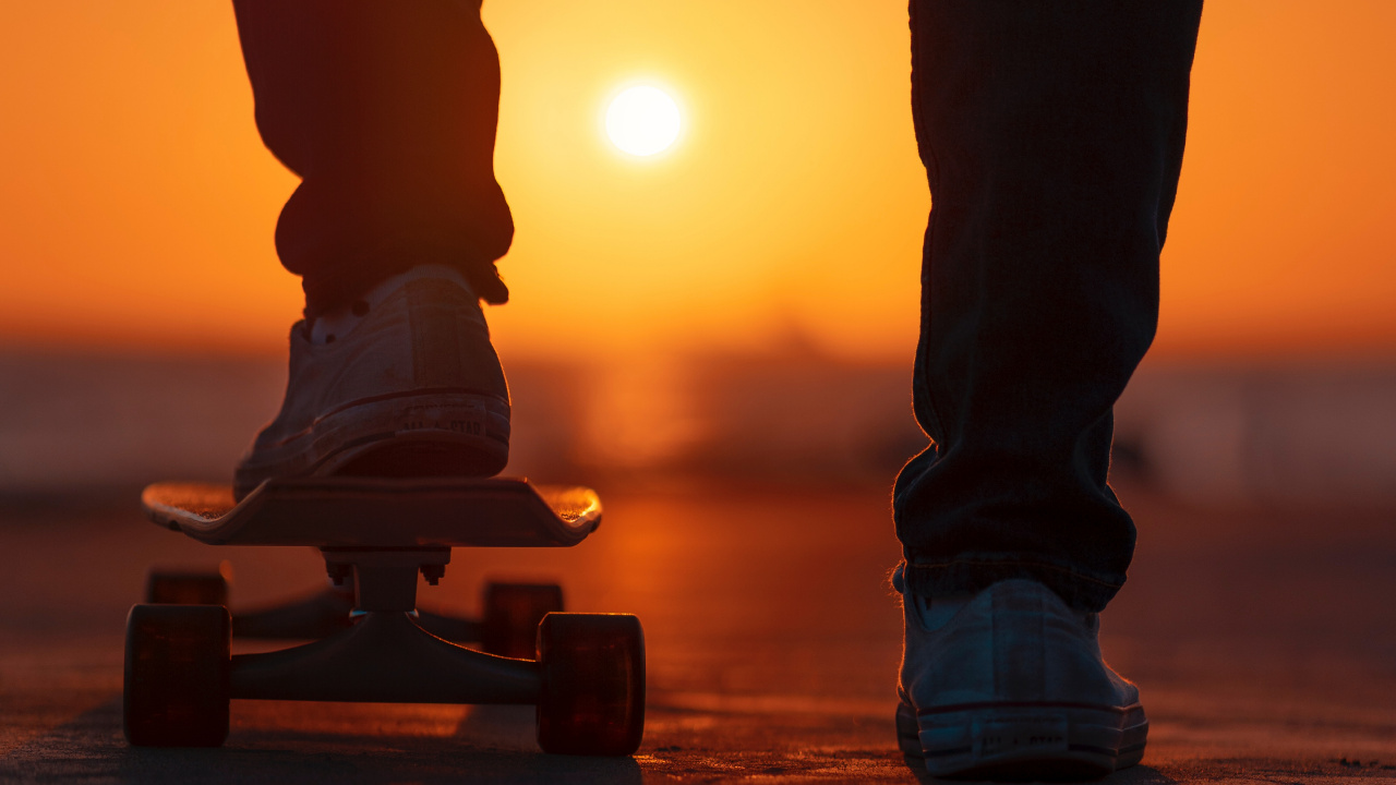 Person in Black Pants and White Sneakers Standing on Brown Wooden Skateboard. Wallpaper in 1280x720 Resolution