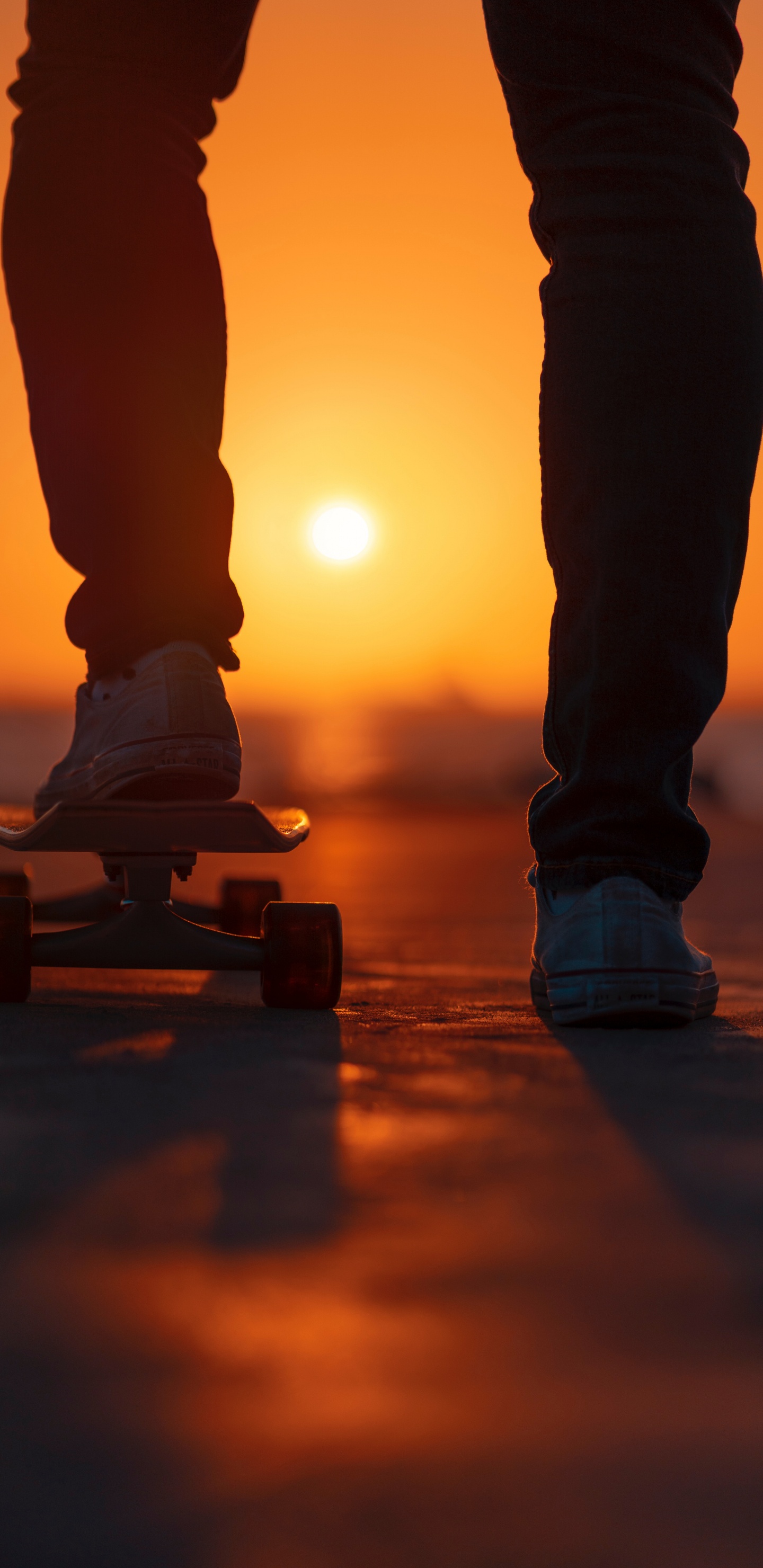 Person in Black Pants and White Sneakers Standing on Brown Wooden Skateboard. Wallpaper in 1440x2960 Resolution