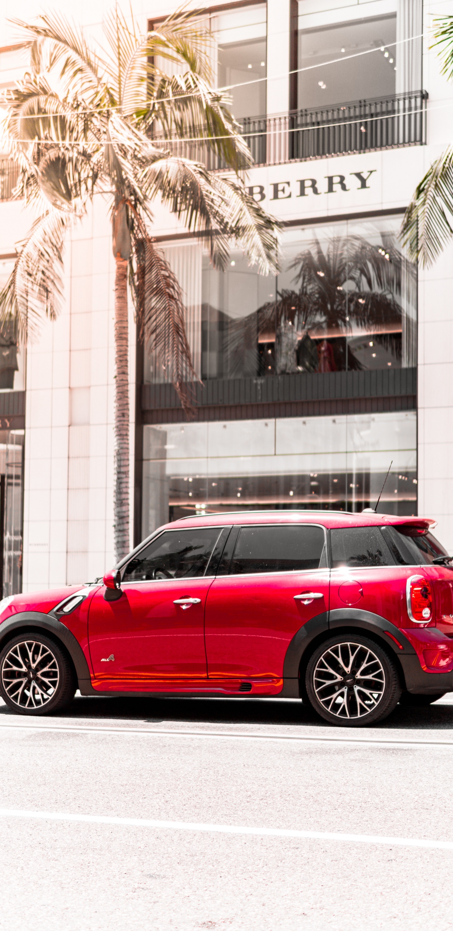 Red Sedan Parked Near Building During Daytime. Wallpaper in 1440x2960 Resolution