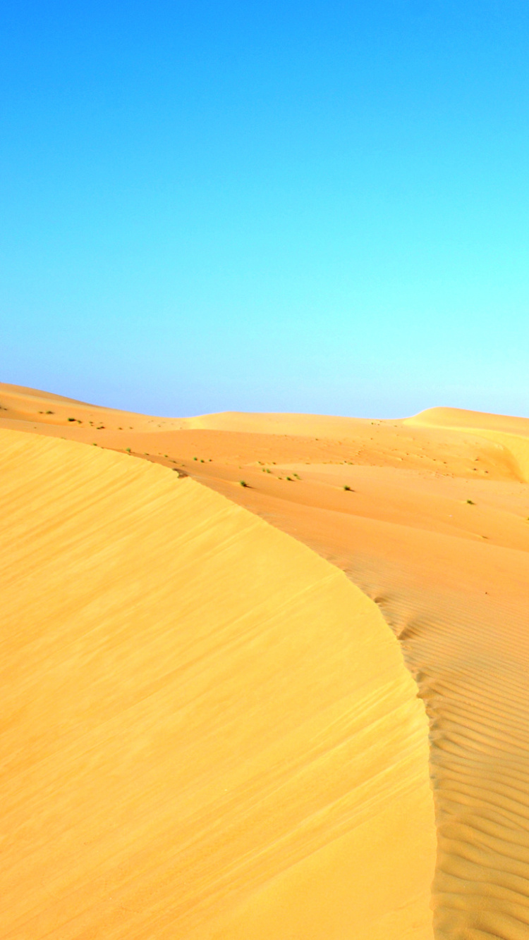 Brown Sand Under Blue Sky During Daytime. Wallpaper in 750x1334 Resolution