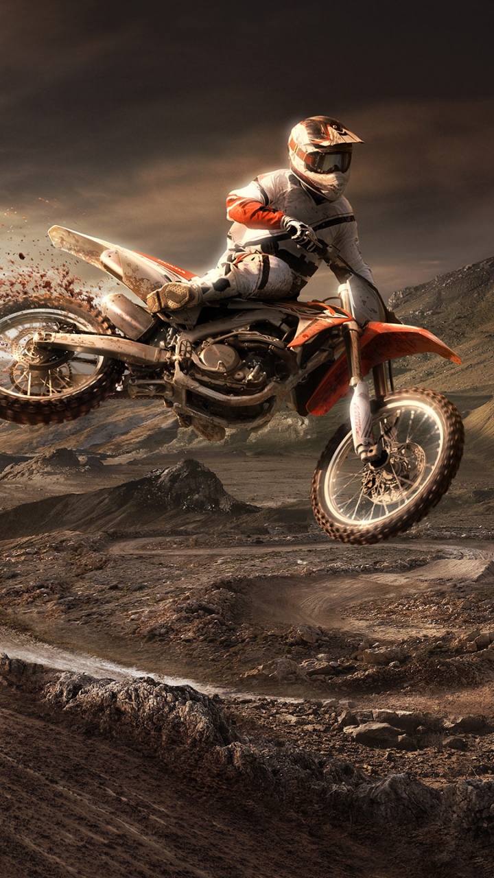 Man Riding Motocross Dirt Bike on Brown Sand. Wallpaper in 720x1280 Resolution