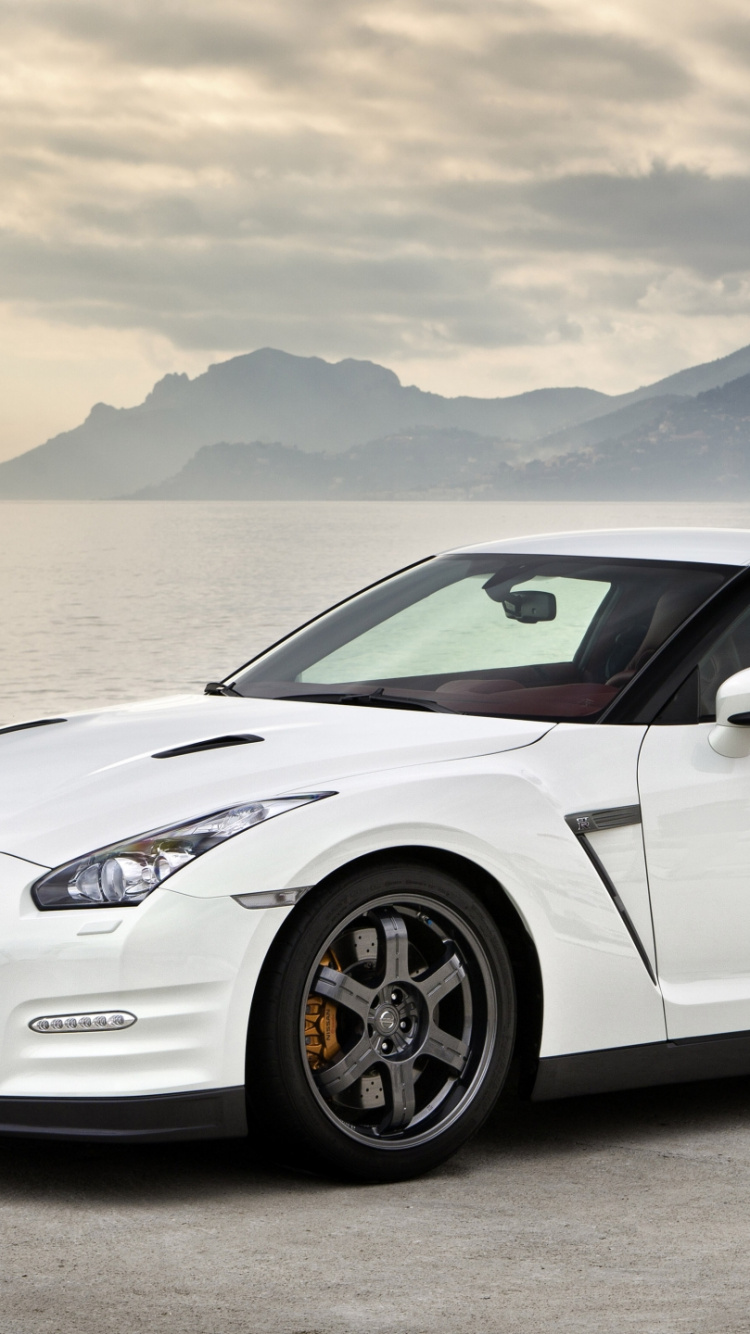 White Porsche 911 Parked on Seashore During Daytime. Wallpaper in 750x1334 Resolution