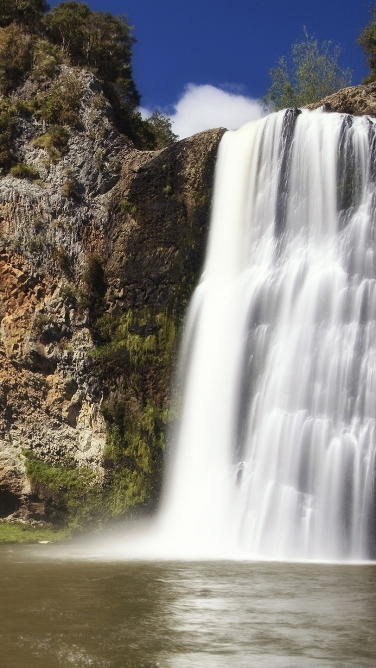 Waterfalls Near Green Trees Under Blue Sky During Daytime. Wallpaper in 750x1334 Resolution