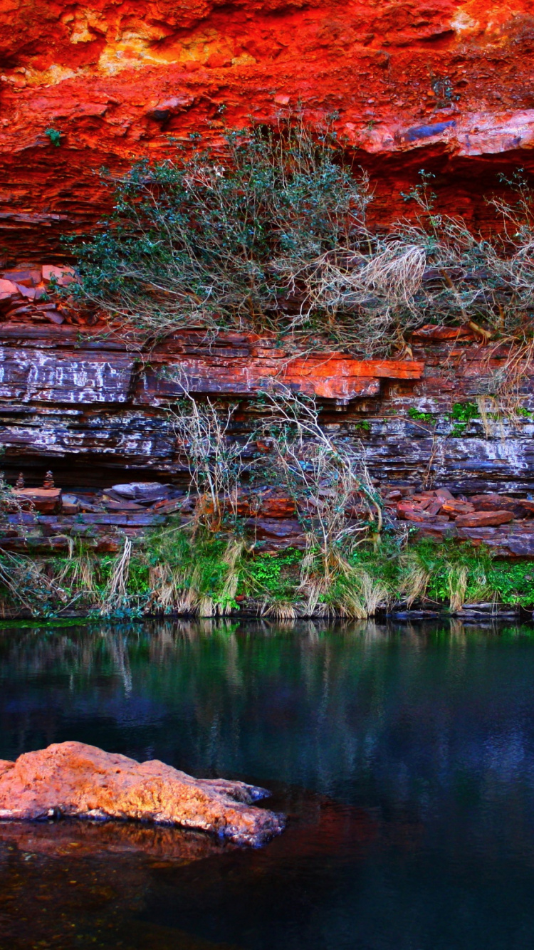 Brown Rock Formation Beside Body of Water During Daytime. Wallpaper in 750x1334 Resolution