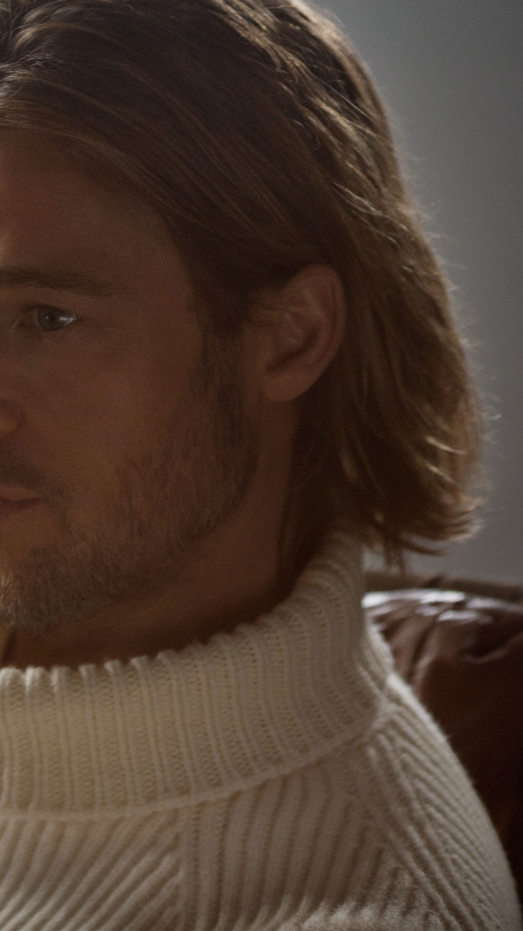 Man in White Knit Sweater Sitting on Brown Leather Couch. Wallpaper in 750x1334 Resolution