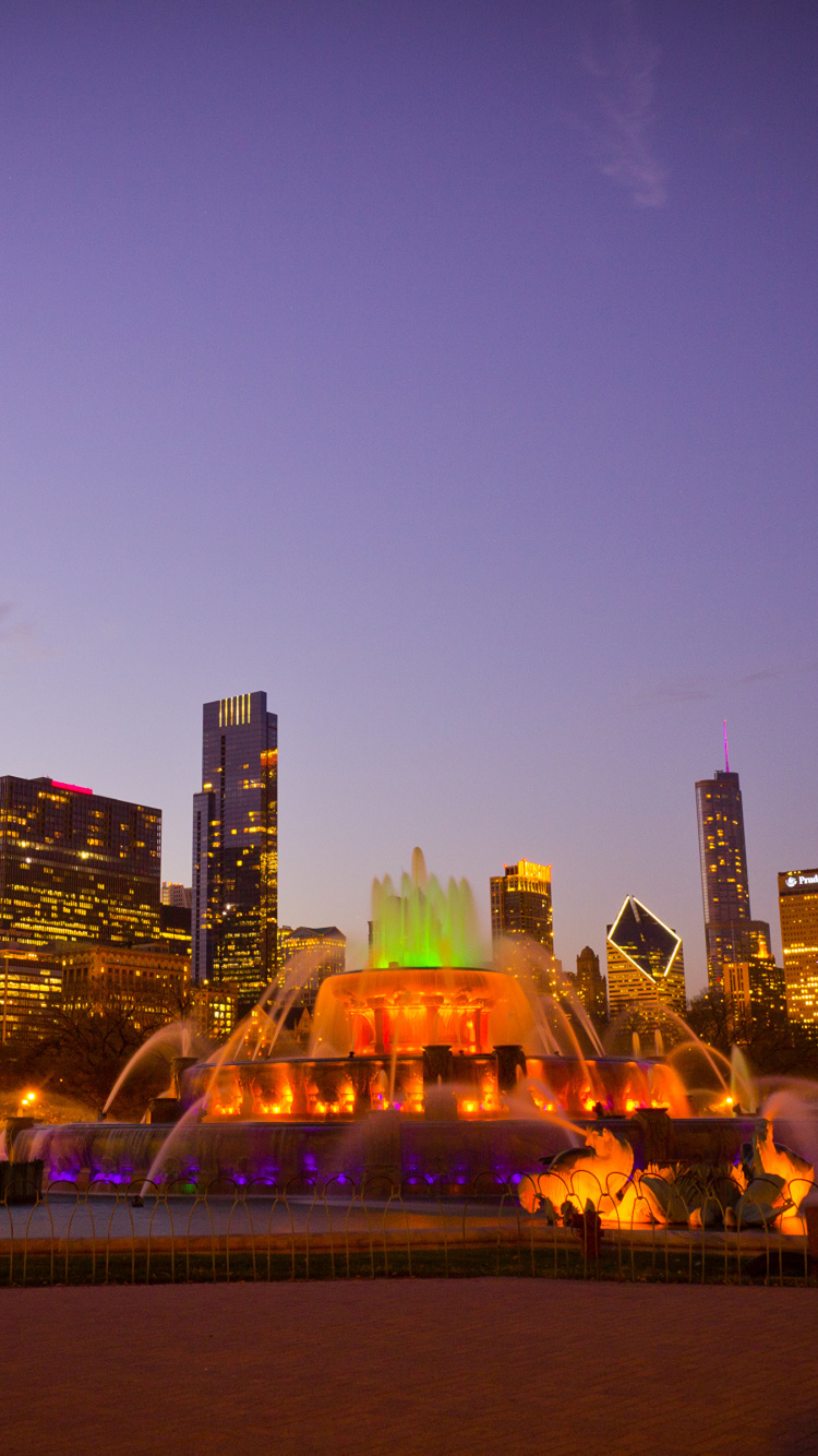 City Skyline With Lights Turned on During Night Time. Wallpaper in 750x1334 Resolution