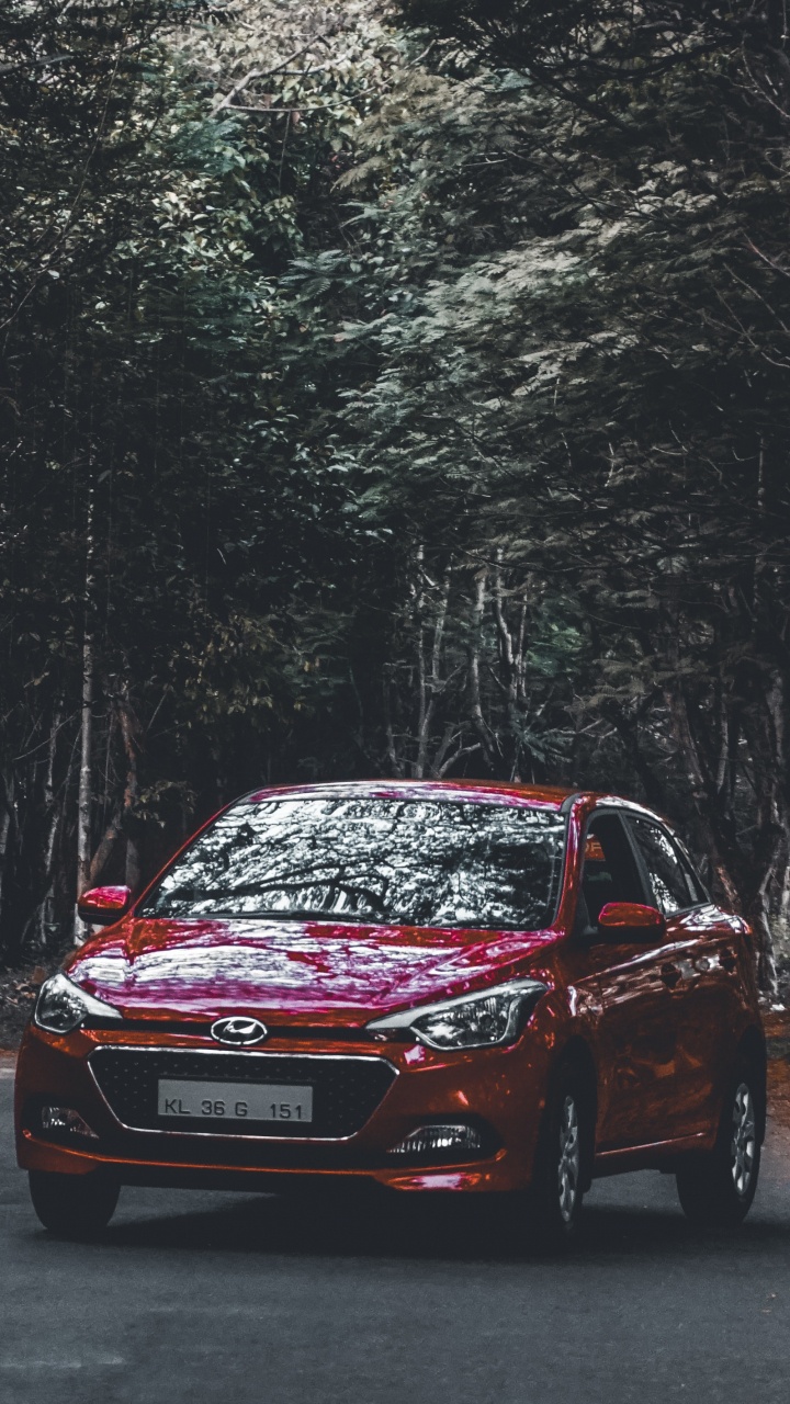 Red Honda Car on Road in Between Trees During Daytime. Wallpaper in 720x1280 Resolution