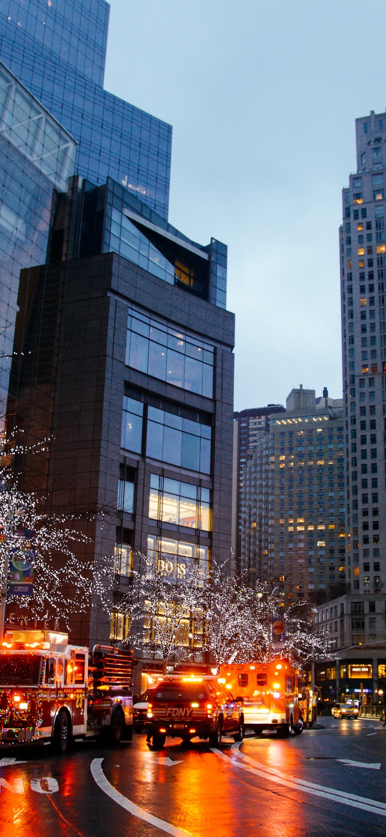 Cars on Road Near High Rise Buildings During Night Time. Wallpaper in 1242x2688 Resolution