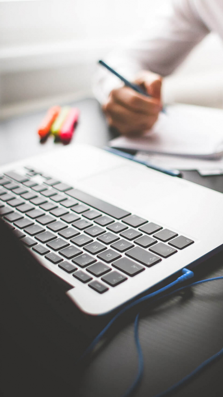 Personne en Chemise Blanche Utilisant Macbook Pro. Wallpaper in 750x1334 Resolution