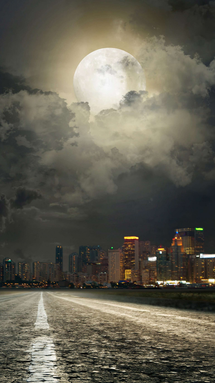 City Skyline With Lights Turned on During Night Time. Wallpaper in 750x1334 Resolution