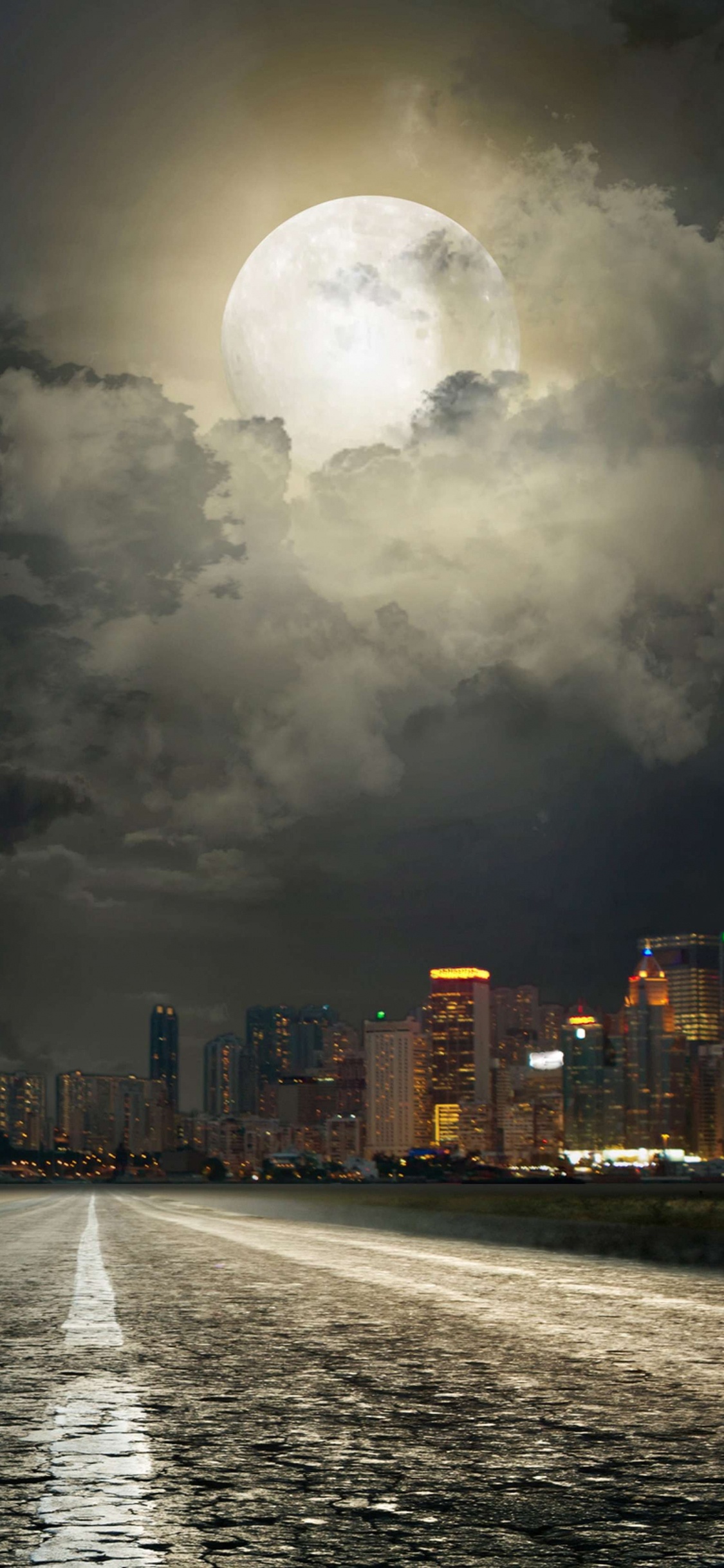 Skyline Der Stadt Mit Nachts Eingeschalteten Lichtern. Wallpaper in 1125x2436 Resolution