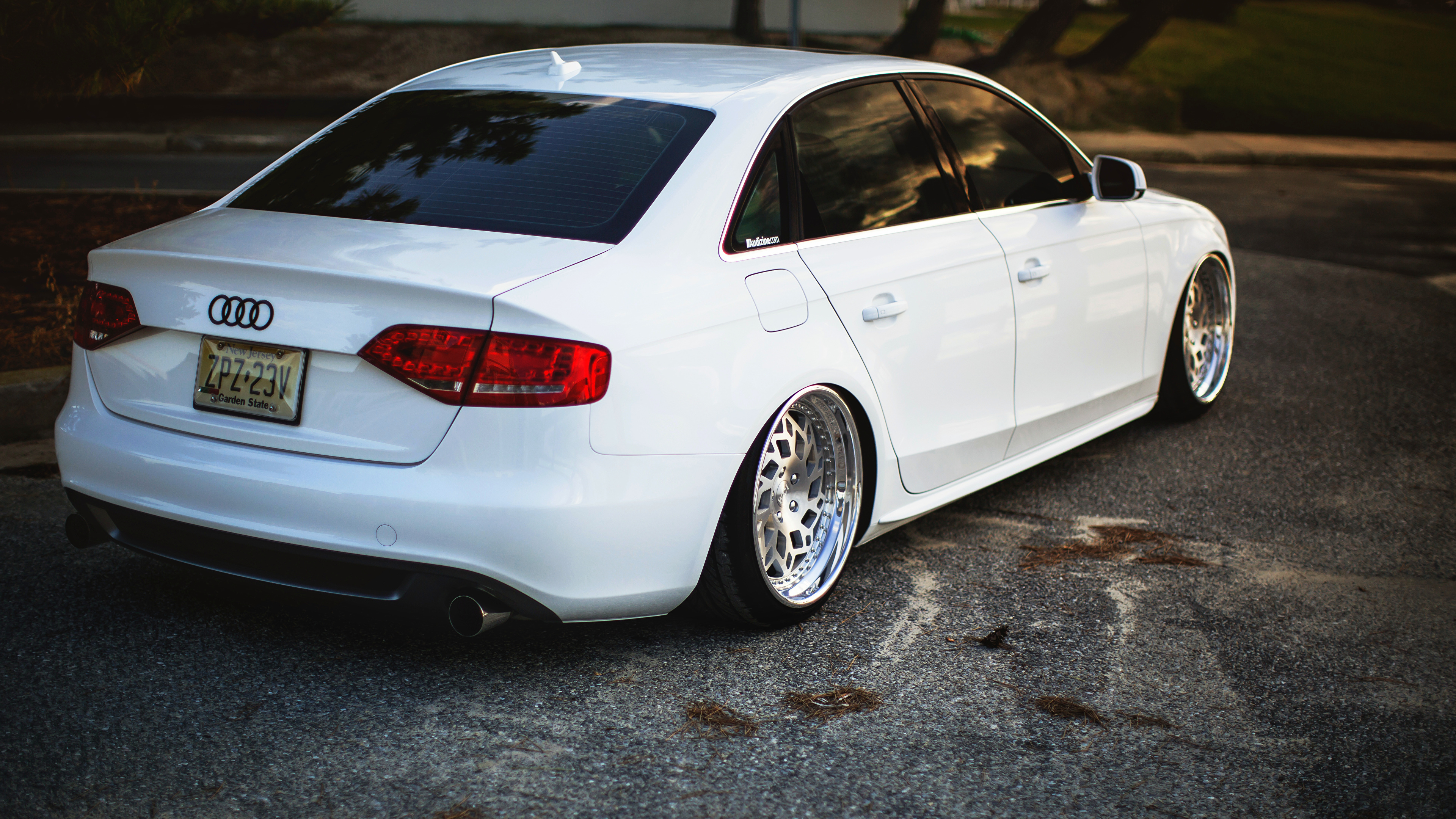 White Sedan on Gray Concrete Road. Wallpaper in 3840x2160 Resolution