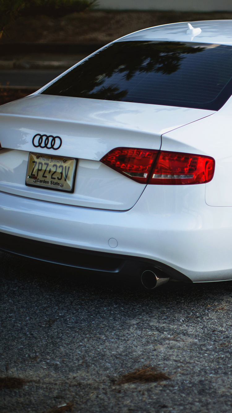 White Sedan on Gray Concrete Road. Wallpaper in 750x1334 Resolution