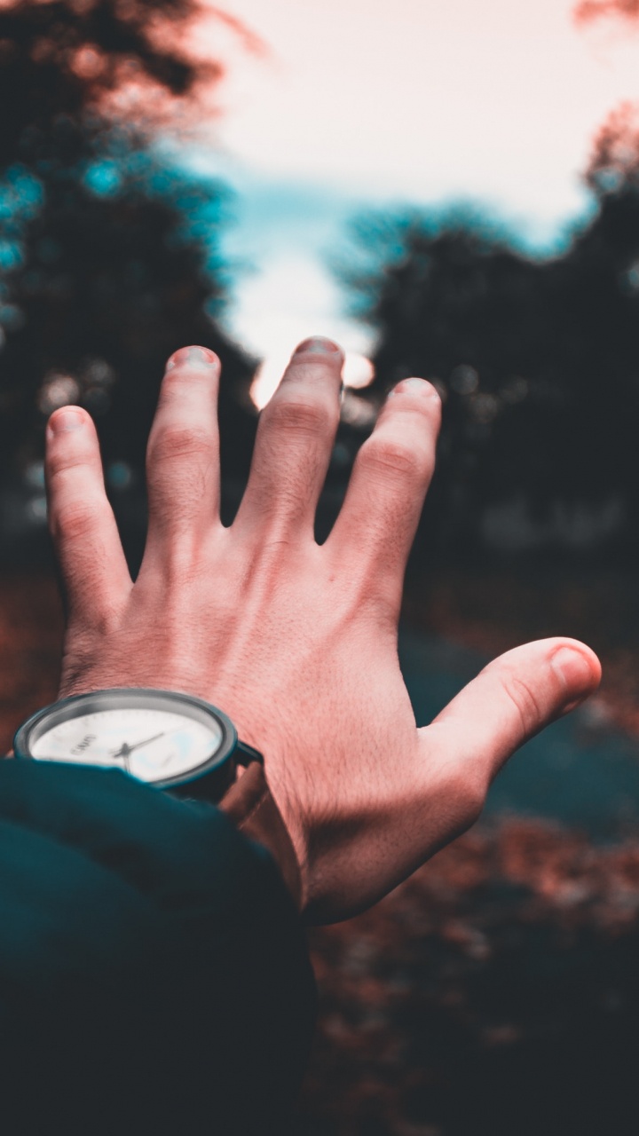 Persona Con Camisa de Manga Larga Negra Levantando la Mano Izquierda. Wallpaper in 720x1280 Resolution