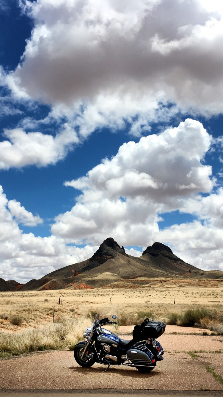 Black Motorcycle on Brown Field Under White Clouds and Blue Sky During Daytime. Wallpaper in 750x1334 Resolution