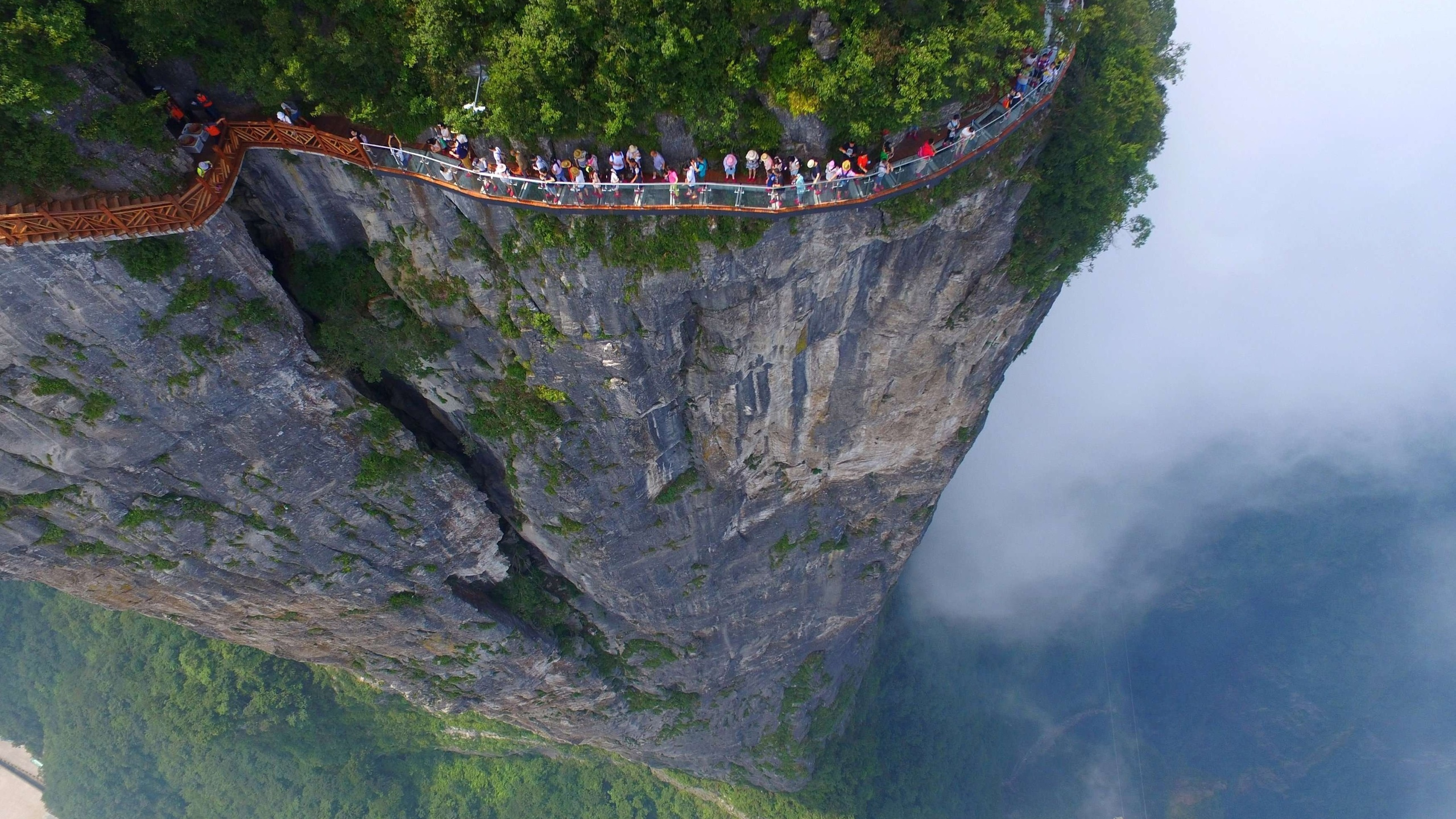 People Walking on Bridge Over The River. Wallpaper in 2560x1440 Resolution