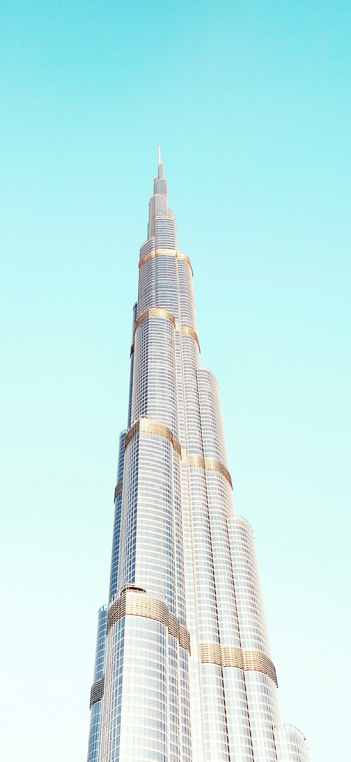 White and Black Concrete Building Under Blue Sky During Daytime. Wallpaper in 1125x2436 Resolution
