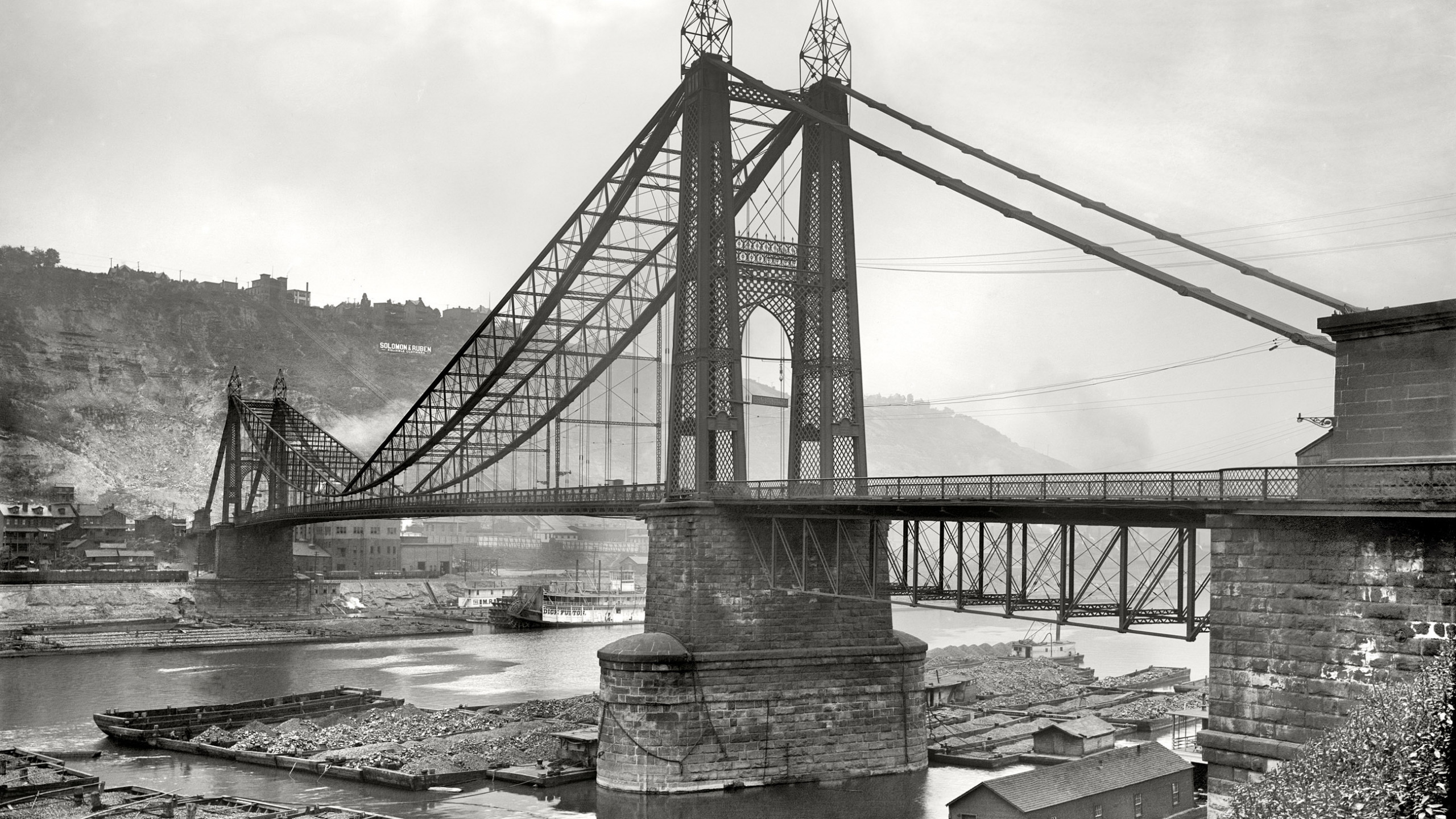 Grayscale Photo of Bridge Over River. Wallpaper in 2560x1440 Resolution