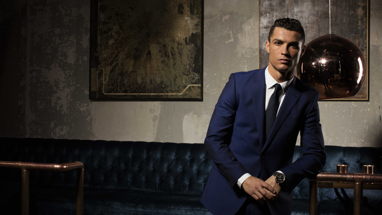 Man in Black Suit Jacket and Black Pants Sitting on Blue Sofa. Wallpaper in 1280x720 Resolution