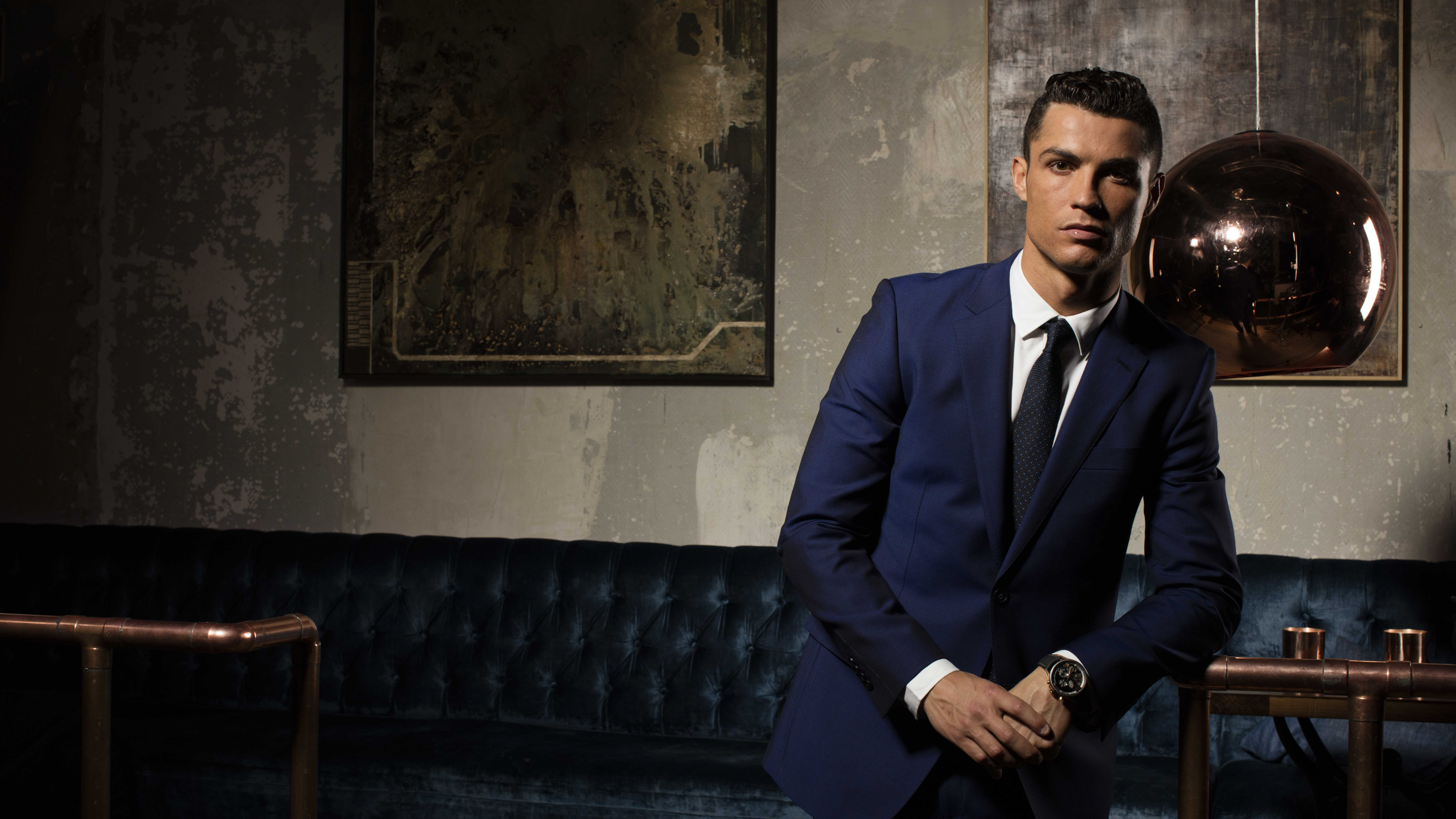 Man in Black Suit Jacket and Black Pants Sitting on Blue Sofa. Wallpaper in 7680x4320 Resolution