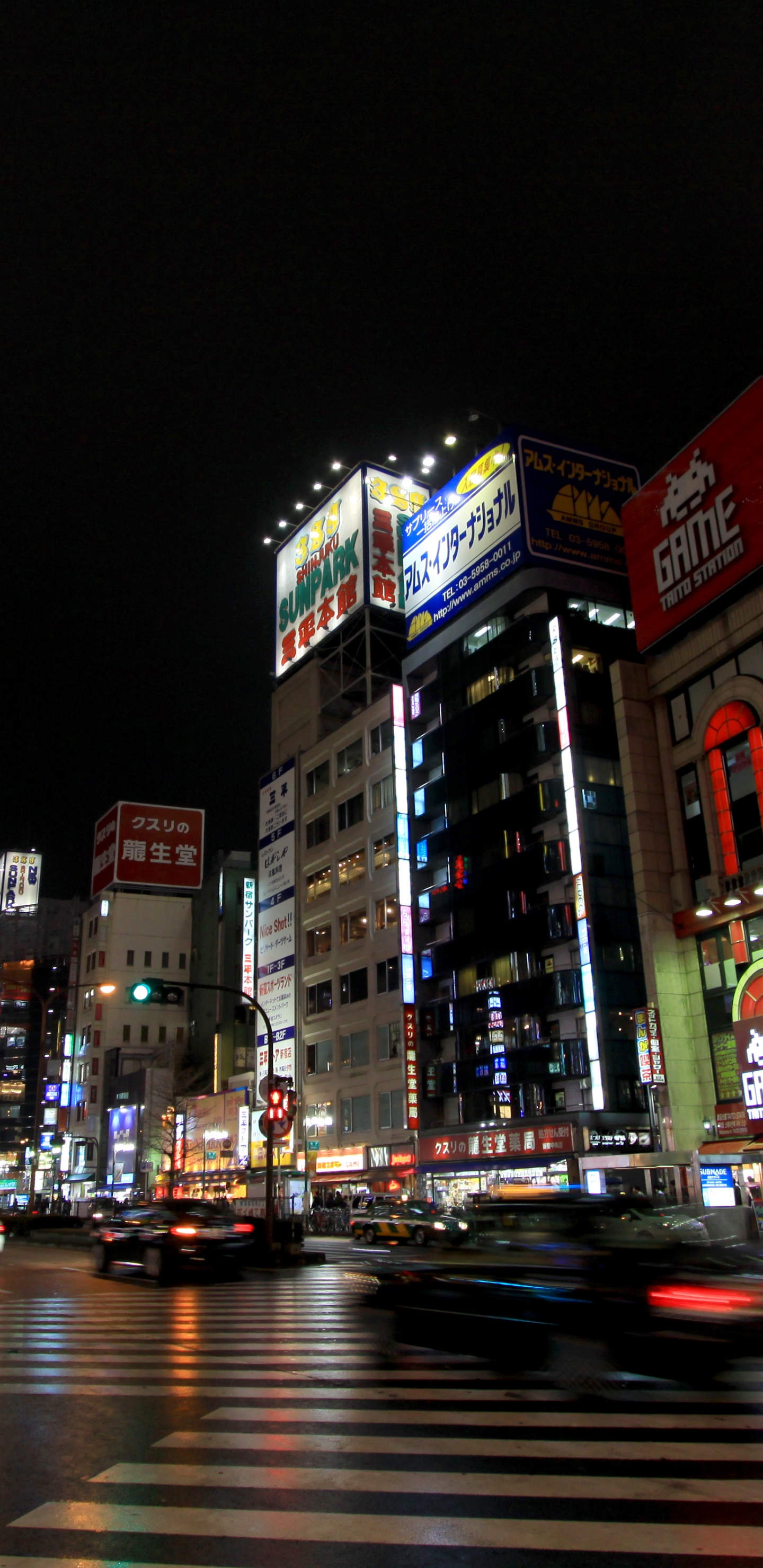 Cars on Road Near Buildings During Night Time. Wallpaper in 1440x2960 Resolution