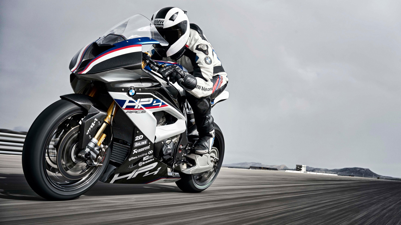 Man in Black and White Motorcycle Suit Riding on Black and White Sports Bike. Wallpaper in 1366x768 Resolution