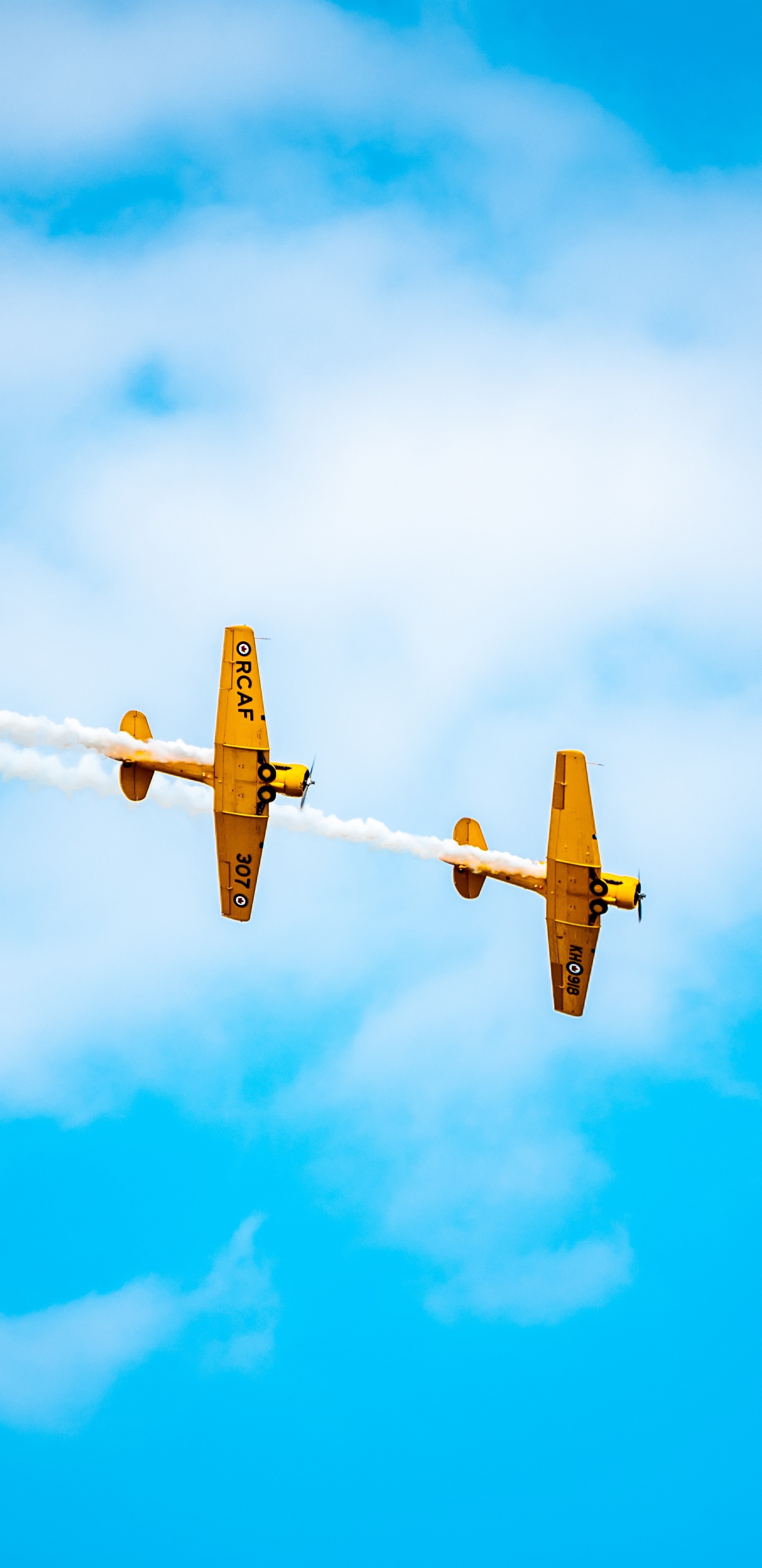 Yellow Plane in Mid Air Under Blue Sky During Daytime. Wallpaper in 1440x2960 Resolution