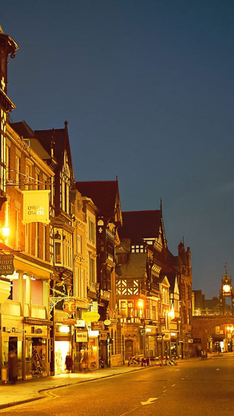 Cars Parked Beside The Road in Between Buildings During Night Time. Wallpaper in 750x1334 Resolution