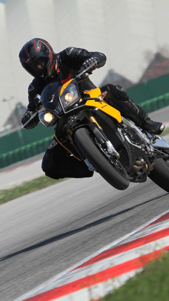 Man in Yellow and Black Jacket Riding Yellow Sports Bike on Track Field During Daytime. Wallpaper in 720x1280 Resolution