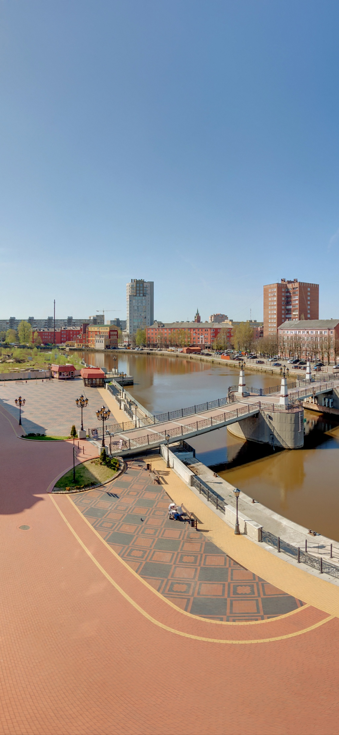White and Brown Concrete Building Near Body of Water During Daytime. Wallpaper in 1125x2436 Resolution