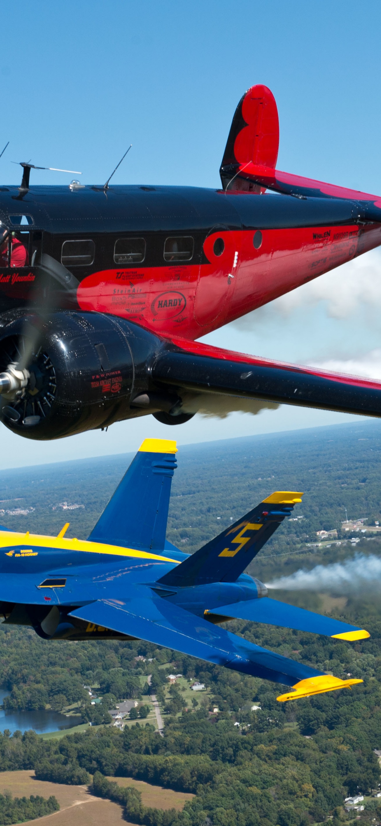 Blue and Red Jet Plane on Air During Daytime. Wallpaper in 1242x2688 Resolution