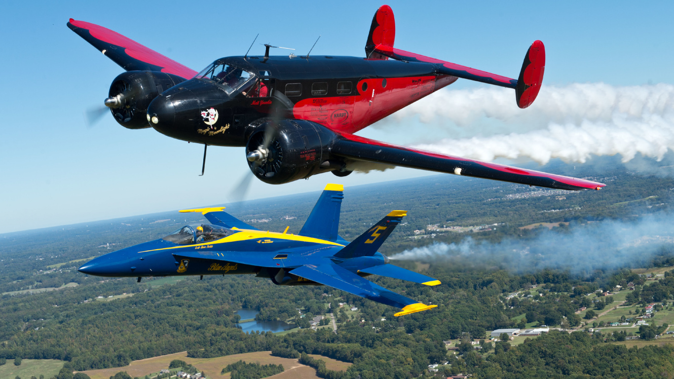 Blue and Red Jet Plane on Air During Daytime. Wallpaper in 1366x768 Resolution