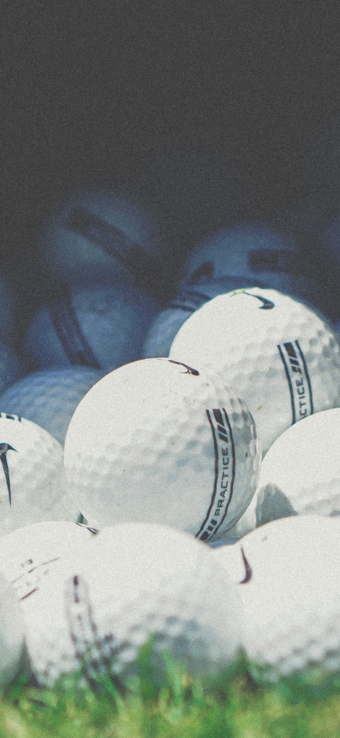 White Golf Balls in Black Container. Wallpaper in 1125x2436 Resolution