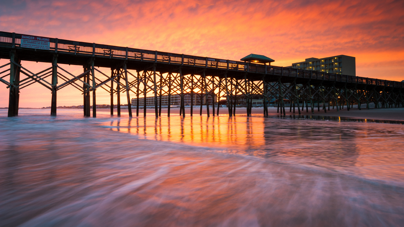 Black Metal Bridge Over The Sea During Sunset. Wallpaper in 1366x768 Resolution