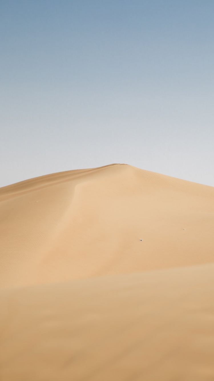 Brown Sand Under Blue Sky During Daytime. Wallpaper in 750x1334 Resolution