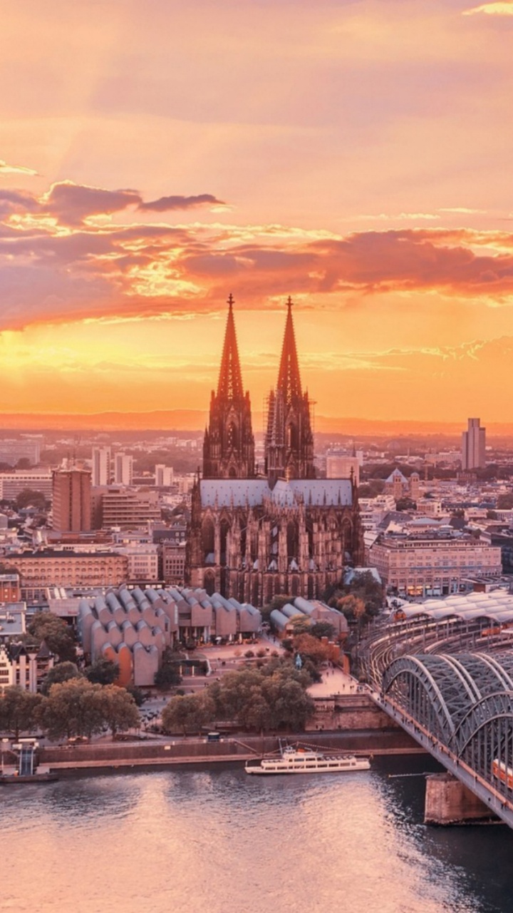 White and Blue Boat on Water Near City Buildings During Sunset. Wallpaper in 720x1280 Resolution