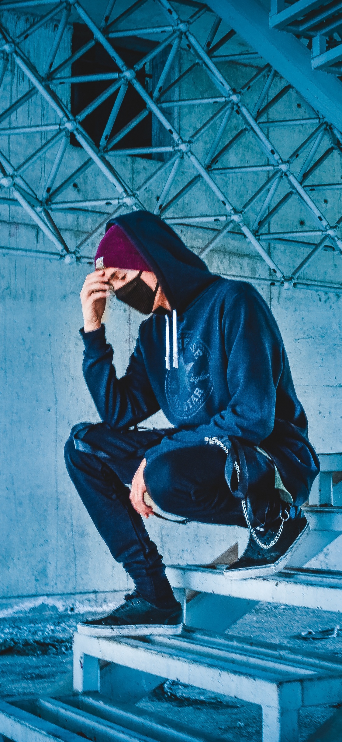 Man in Black Hoodie and Black Pants Sitting on Concrete Stairs. Wallpaper in 1125x2436 Resolution