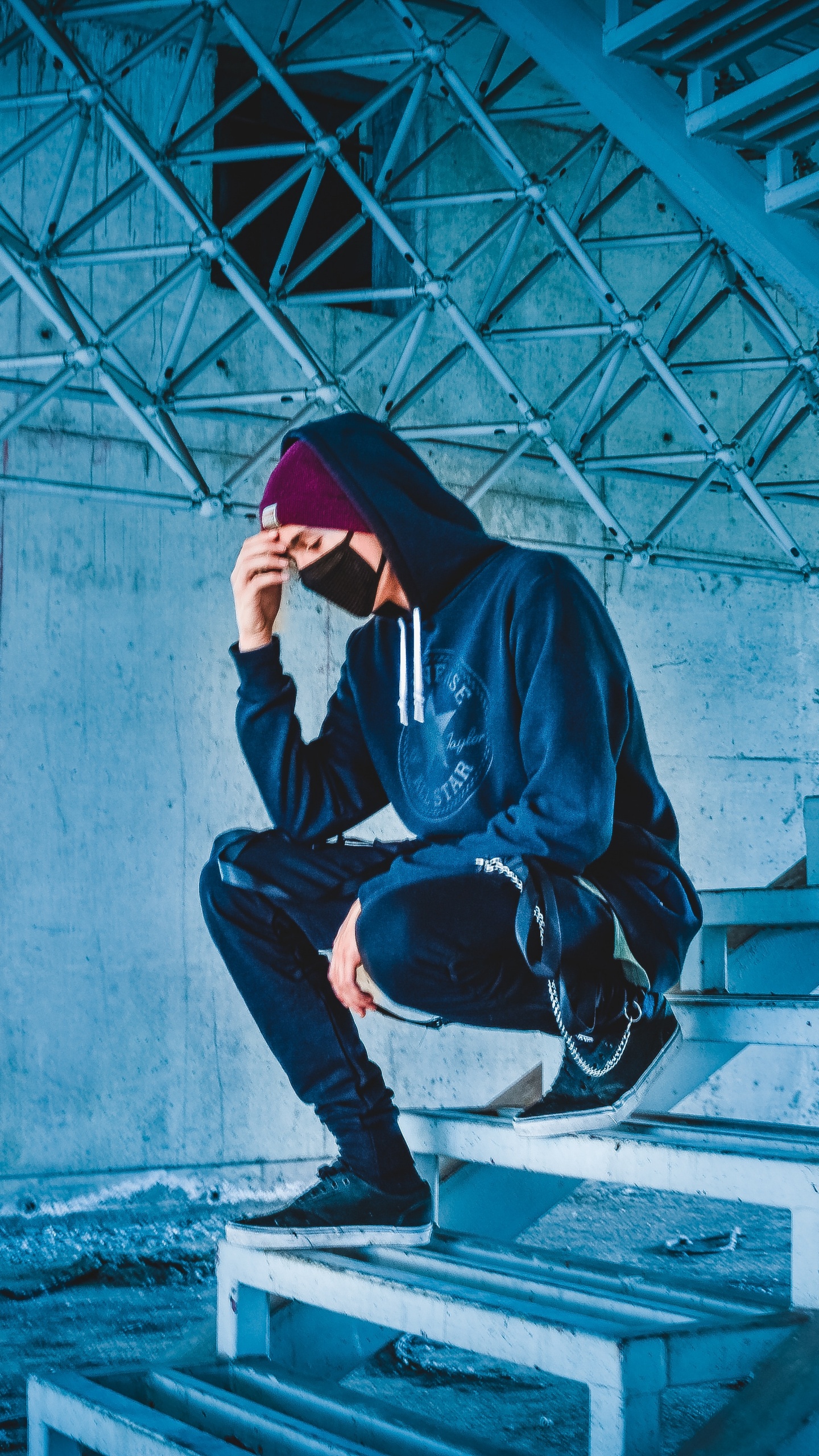 Man in Black Hoodie and Black Pants Sitting on Concrete Stairs. Wallpaper in 1440x2560 Resolution