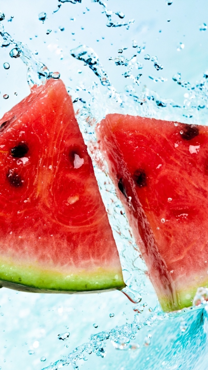 Sliced Watermelon on Water With Water Droplets. Wallpaper in 720x1280 Resolution