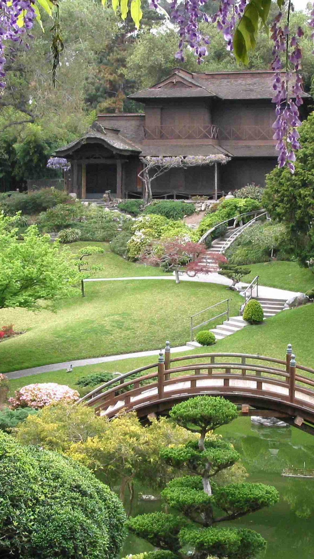 Brown Wooden Bridge Over Green Grass Field. Wallpaper in 1080x1920 Resolution
