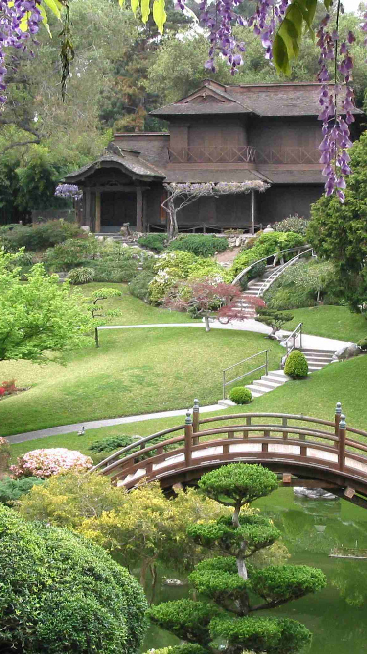 Brown Wooden Bridge Over Green Grass Field. Wallpaper in 750x1334 Resolution