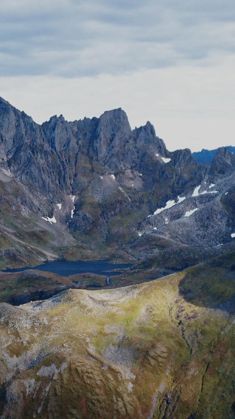 Green and Brown Mountains Under White Clouds During Daytime. Wallpaper in 750x1334 Resolution