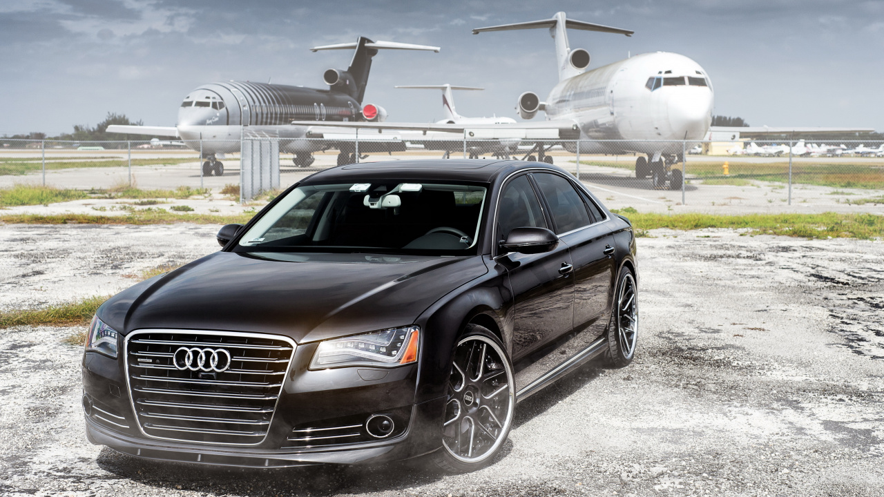 Black Audi Sedan Parked Near White Airplane During Daytime. Wallpaper in 1280x720 Resolution