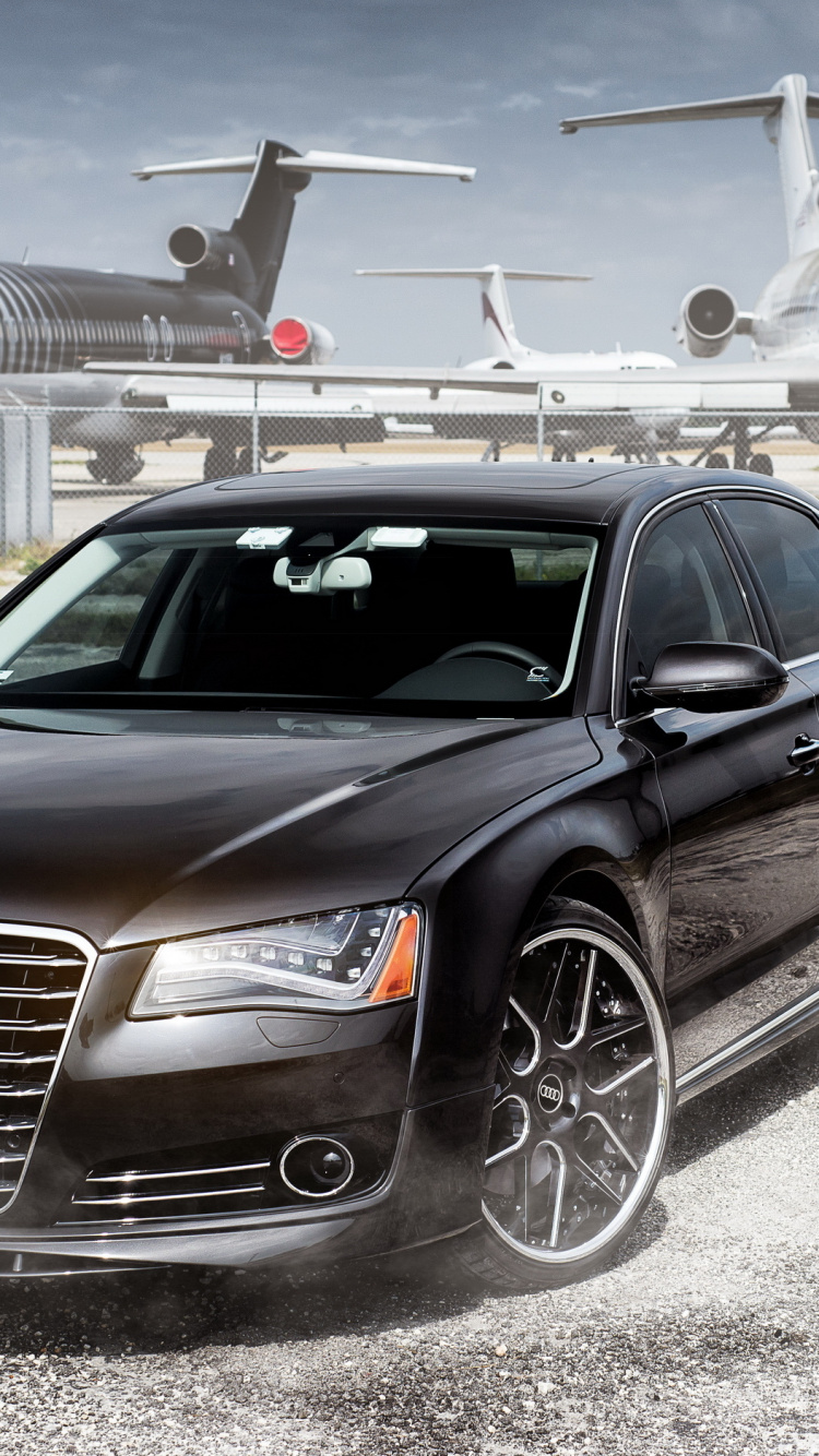 Black Audi Sedan Parked Near White Airplane During Daytime. Wallpaper in 750x1334 Resolution
