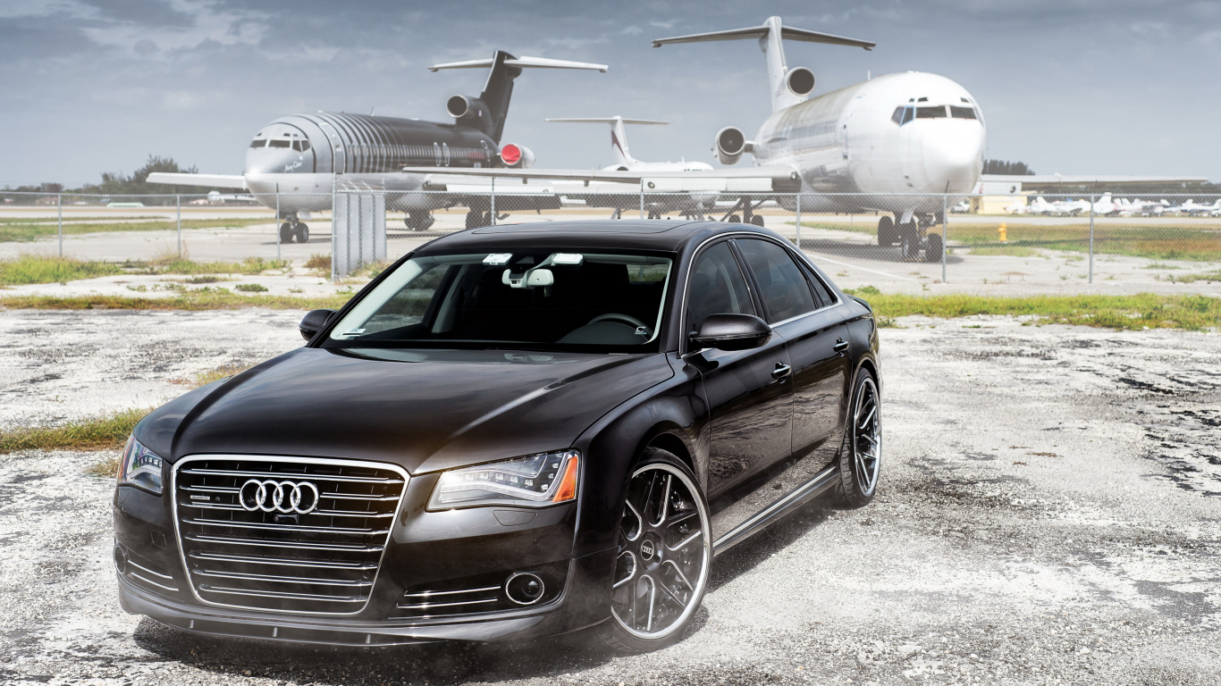 Audi Sedán Negro Estacionado Cerca Del Avión Blanco Durante el Día. Wallpaper in 1366x768 Resolution