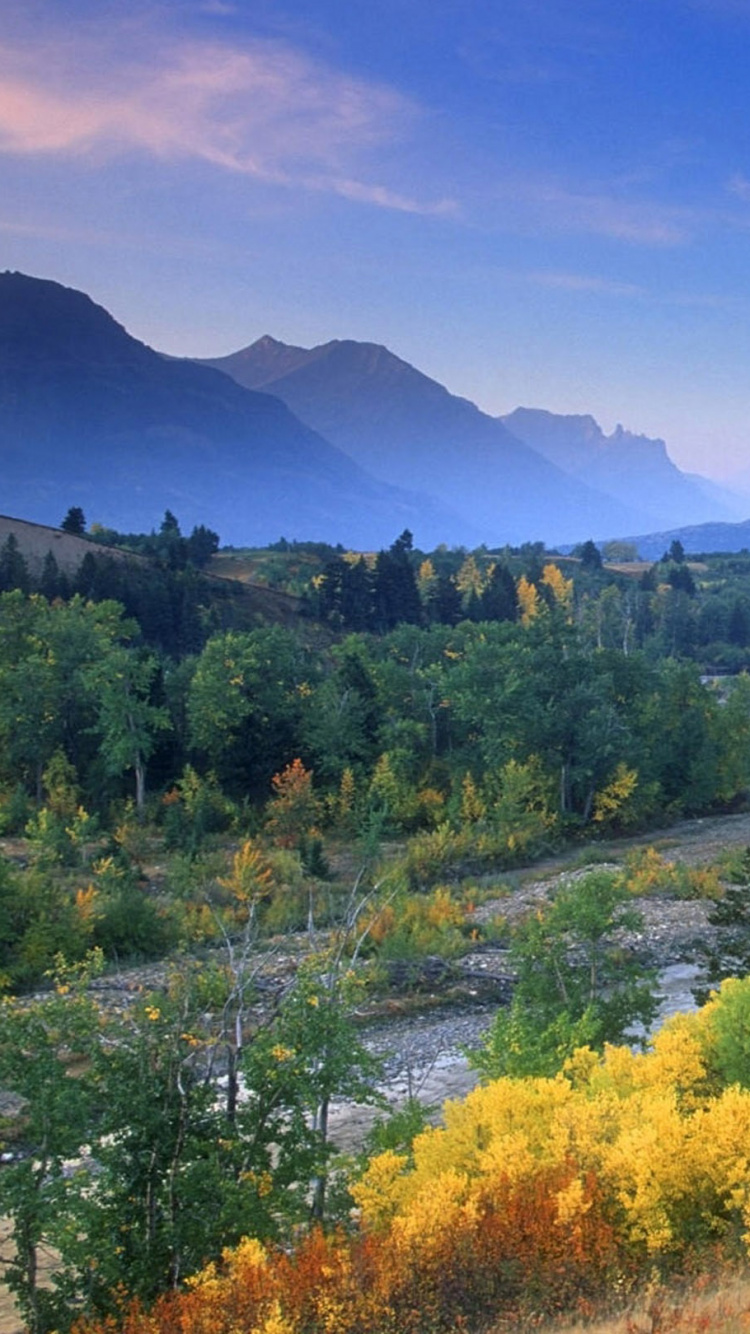 Green Trees and Mountains Under Blue Sky During Daytime. Wallpaper in 750x1334 Resolution
