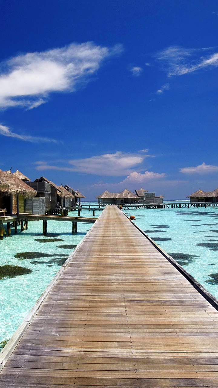 Brown Wooden Dock on Blue Water Under Blue Sky During Daytime. Wallpaper in 720x1280 Resolution