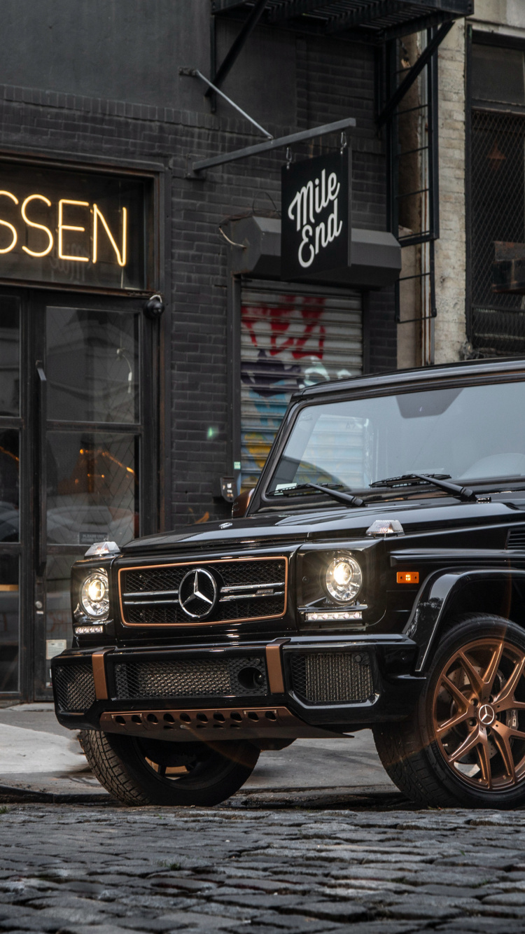 Black Suv Parked Beside Building During Daytime. Wallpaper in 750x1334 Resolution